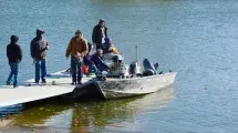 photo of people on a boat at the fishing dock