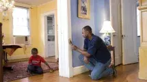 Parent painting while kid plays