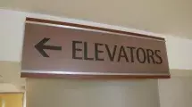 Sign with arrow to Elevators.