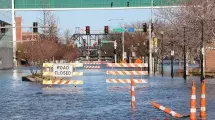 Road closed barricades flooded in water on River Drive.