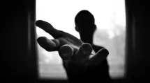 dark figure reaching out a helping hand