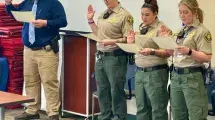 Three corrections officers being sworn in.