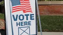 Sign that reads "Vote Here"