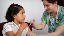 Child receiving immunization in arm