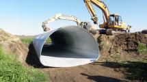 Culvert being lowered into the ground.