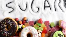 'Sugar' spelt in spilled sugar, images of donuts, and various sweets.