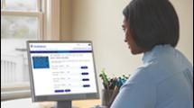 Woman looking at monitor of desktop computer