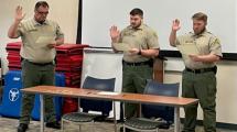 Two corrections officers being sworn in.