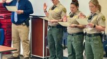 Three corrections officers being sworn in.