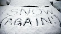 Words Snow again written in the snow
