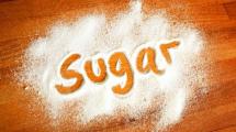 The word 'Sugar' spelt out in spilled sugar.