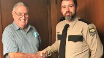 Board Chairman John "Skip" O'Donnell shaking Park Ranger Erik Johnson's hand.