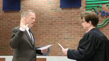 Swearing in Treasurer Mike Fennelly.