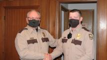 Conservation Executive Director Roger Kean shaking new Park Ranger Brad Taylor's hand. 