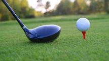 photo of a golf club and a ball on a tee