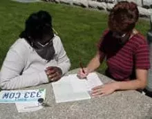 Meeting with the buyer and going over paperwork.