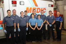 Participants standing in front of an ambulance.